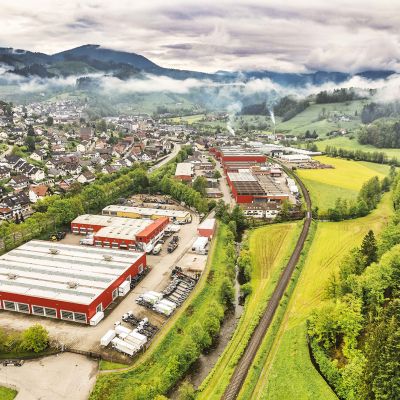 Aerial view of the DOLL plant in Oppenau, in a misty valley in the Black Forest